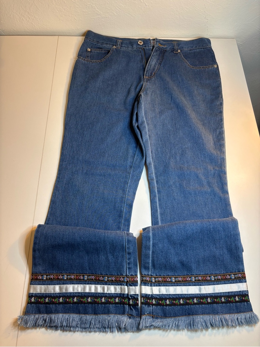 Andrew's Blues blue cotton jeans with embroidered floral trim and fringe